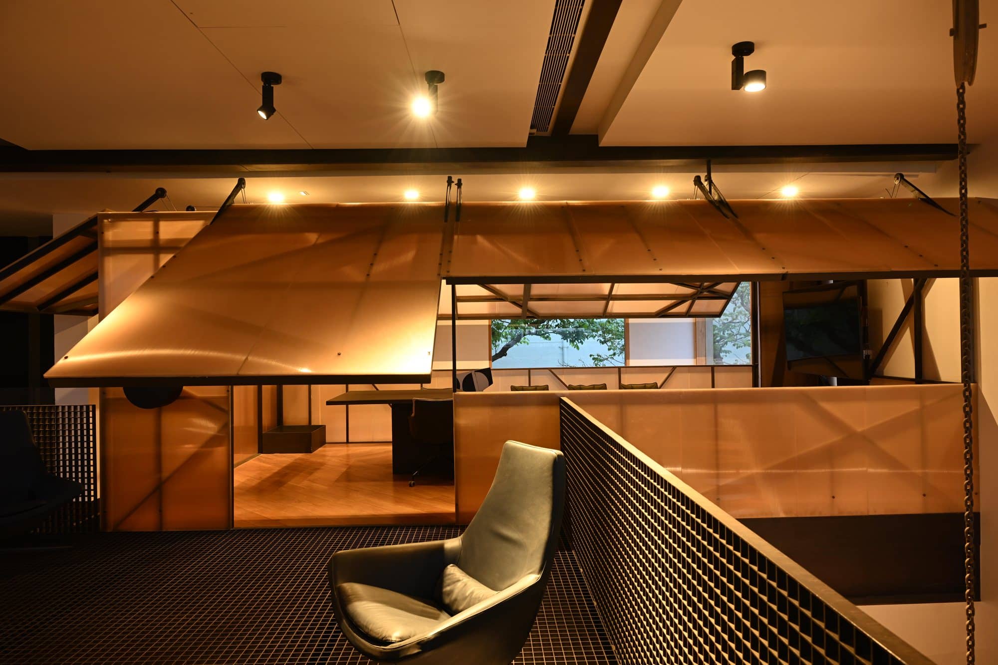 Curved timber canopy loft with sculptural seating — daylight